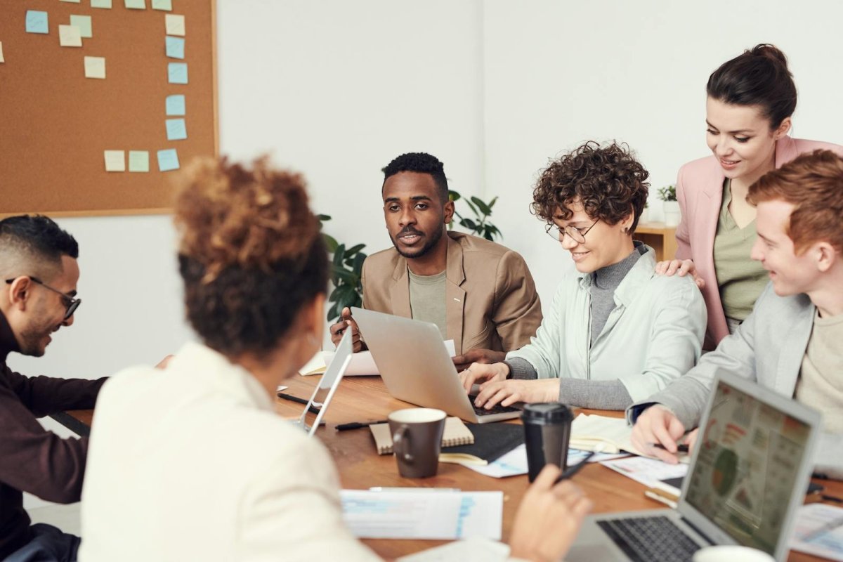 Diverse professional team collaborating - PMTS 6 years building institutional trading AI